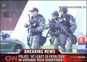 Law enforcement officers arrive at the scene of a shooting at the Virginia Tech campus in Blacksburg, Va.