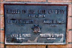 The plaque on the monument to the four CHP officers killed in the Newhall Incident.