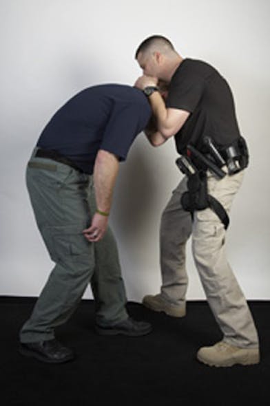 After achieving the Thai Clinch, step to the outside of the suspect&apos;s leg