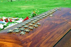 SEAL Michael Monsoor&apos;s coffin covered with the gold SEAL emblems placed by his brothers in arms.