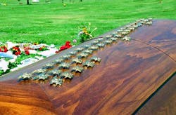SEAL Michael Monsoor's coffin covered with the gold SEAL emblems placed by his brothers in arms. SEAL Michael Monsoor's coffin covered with the gold SEAL emblems placed by his brothers in arms.