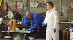 Investigators catalog weapons and evidence at the Phoenix tire center. Investigators catalog weapons and evidence at the Phoenix tire center.