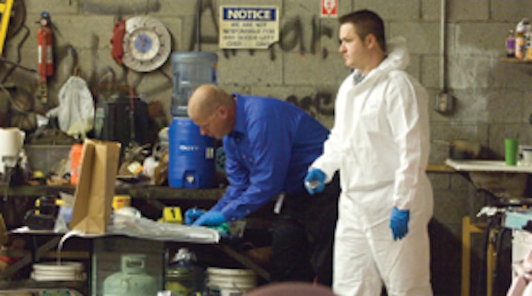 Investigators catalog weapons and evidence at the Phoenix tire center.