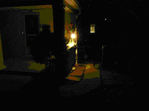 This image shows an individual hiding behind a 'wall of light' in front of a building.