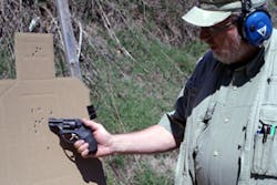 The author examines five shot groups explained in the article. Note the MagTech hits marked with a black line at 12 o’clock, compared to the unmarked group of Speer 135 grain +P GDHP. The author examines five shot groups explained in the article. Note the MagTech hits marked with a black line at 12 o’clock, compared to the unmarked group of Speer 135 grain +P GDHP.