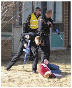 First responders in the Concordia University Wisconsin training check the status of a victim. First responders in the Concordia University Wisconsin training check the status of a victim.