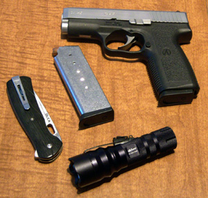 The ITC HX120 shown with a Buck Knives Vantage Pro folding lockblade, the author's Kahr CW4543 .45ACP pistol and one spare magazine for same.