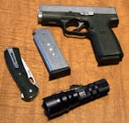 The ITC HX120 shown with a Buck Knives Vantage Pro folding lockblade, the author&apos;s Kahr CW4543 .45ACP pistol and one spare magazine for same.