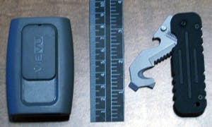 The VIEVU PVR-PRO2 shown with a ruler and a BLACKHAWK! Hawk Hook rescue tool. It&apos;s about the size of an old-style pager.