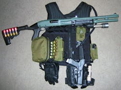 Shotgun and handgun 'system' resting on the vest that holds the rest. Shotgun and handgun 'system' resting on the vest that holds the rest.