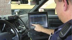 New London, N.H., Police Officer Rob Thorp views dispatch information on a mobile data terminal.