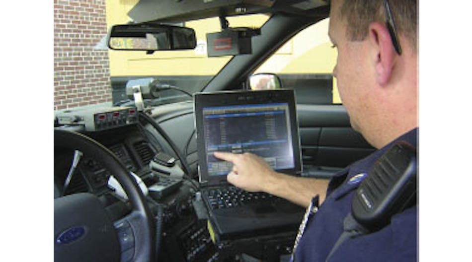 New London, N.H., Police Officer Rob Thorp views dispatch information on a mobile data terminal.