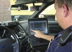 New London, N.H., Police Officer Rob Thorp views dispatch information on a mobile data terminal.