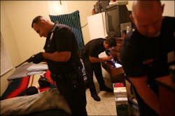 Members of the LAPD's Newton Division Gang Unit discover a gun, cash and drugs during a search of a parolee's apartment. Members of the LAPD's Newton Division Gang Unit discover a gun, cash and drugs during a search of a parolee's apartment.