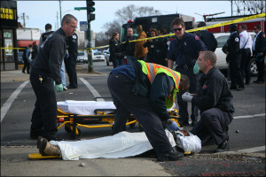 Responders tend to the injured at the scene of a crash and shooting that injured 11 people in Chicago Tuesday.