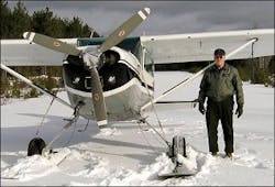 Warden Service Pilot Daryl Gordon is seen standing next to his plane on a frozen lake. Warden Service Pilot Daryl Gordon is seen standing next to his plane on a frozen lake.
