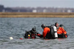 Suffolk County dive team police officers search for possible victims of a suspected serial killer on April 14. Suffolk County dive team police officers search for possible victims of a suspected serial killer on April 14.