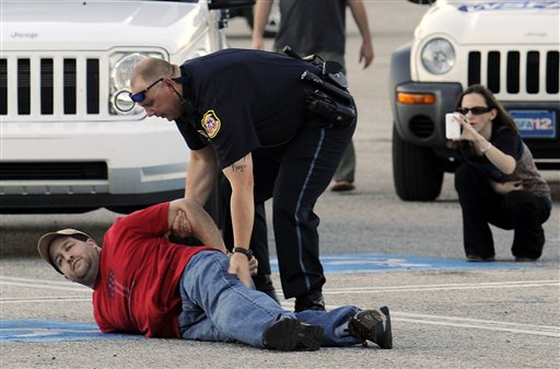 Opelika police take a suspect into custody at Southern Union Community College on Wednesday, April 6.