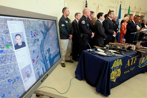 Los Angeles police and federal agents are shown at a news conference to present the results of massive sweep against a street gang accused of drug and weapons trafficking.