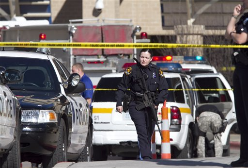 Police officers work the scene at Creighton University Medical Center, Wednesday, April 6