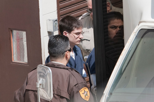 Keith Randulich steps onto a transport bus at the Will County Courthouse on April 14.