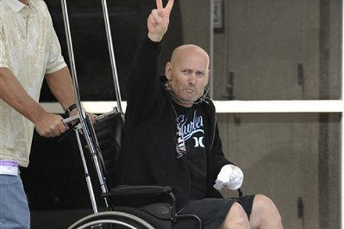 Officer Steve Jenkins is pushed out of the hospital after he was released in time to spend Easter at home with his family.