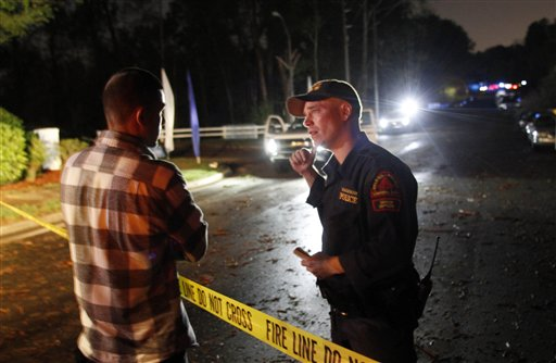 Raleigh police officer J.L. Bloodworth, right, speaks to Jose Arriag Jr. who seeking information about his relatives at Stoney Brook Mobile Home Park, April 16.