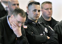 Woburn, Mass., police officers react during the arraignment April 6 in Woburn, Mass. Woburn, Mass., police officers react during the arraignment April 6 in Woburn, Mass.