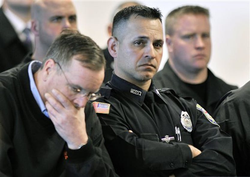 Woburn, Mass., police officers react during the arraignment April 6 in Woburn, Mass.