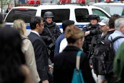 Armed members of an emergency services unit watches over commuters at ground zero in New York. Armed members of an emergency services unit watches over commuters at ground zero in New York.