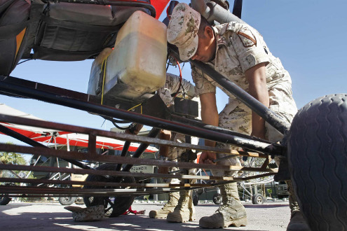 A soldier operates a steel basket beneath an ultra-light aircraft at an army base in Mexicali, Mexico.
