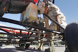 A soldier operates a steel basket beneath an ultra-light aircraft at an army base in Mexicali, Mexico. A soldier operates a steel basket beneath an ultra-light aircraft at an army base in Mexicali, Mexico.