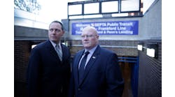 SEPTA Officer Michael Sylvester and FBI Agent Joe Metzinger stand at a subway entrance in Philadelphia.