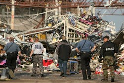 Police officers walk in to the back of a destroyed Wal-Mart store in Joplin, Mo. Police officers walk in to the back of a destroyed Wal-Mart store in Joplin, Mo.