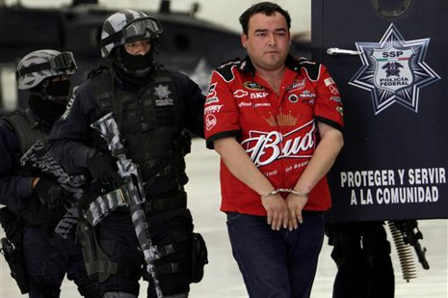 Gilberto Barragan Balderas, right, is escorted by police officers as he is presented to the media.