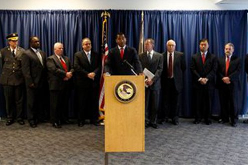 U.S. Attorney Zane Memeger, center, speaks during a news conference.