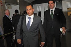 Police officer Ken Moreno, left, exits the courtroomwith his attorney Joe Tacopina.