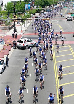 Bicycling police officers from across the nation peddle through Newark, N.J., during the Police Unity Tour.
