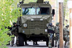 The state police SWAT team has guns drawn during a police standoff with an armed man. The state police SWAT team has guns drawn during a police standoff with an armed man.