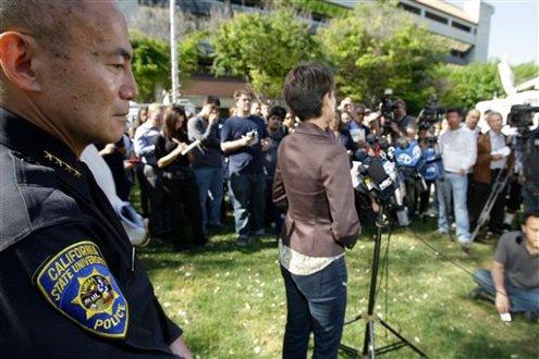 San Jose State University Police Chief Peter Decena, left, listens to SJSU director of media relations Pat Lopes Harris.