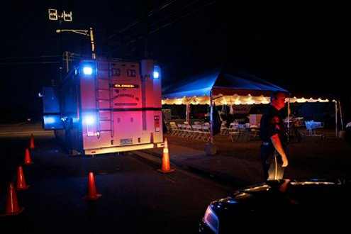 Tuscaloosa Police Sgt. Brent Blankley arrives at a command post as part of nighttime security during a curfew called following last Wednesday's tornado.