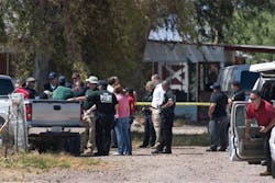 Police investigators comb over a farm property near Wellton, Ariz. Police investigators comb over a farm property near Wellton, Ariz.
