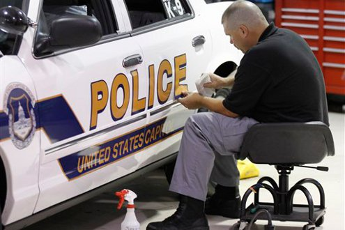 A mechanic places a decal on a newly designed U.S. Capitol Police in Washington, D.C.