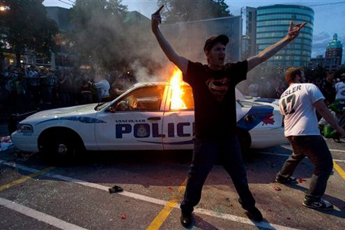 A police car burns during a riot in downtown Vancouver, British Columbia on June 15.
