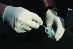Kansas City Police Department&apos;s Crime Scene Technician Greg VanRyn swabs for DNA.