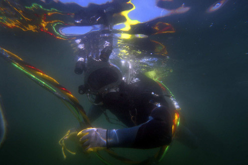 Long Beach Harbor Patrol Officer Eric St. Martin returns to the boat after working underwater in near zero visibility.