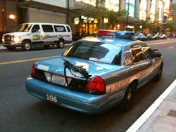 A passerby snapped a shot of an AR-15 rifle on the trunk of an unattended cruiser parked on a city street. A passerby snapped a shot of an AR-15 rifle on the trunk of an unattended cruiser parked on a city street.