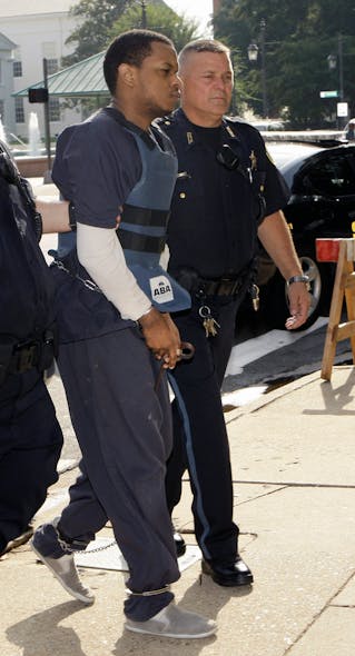 Abdulhakim Muhammad, left, is escorted to the Pulaski County Courthouse in Little Rock, Ark.