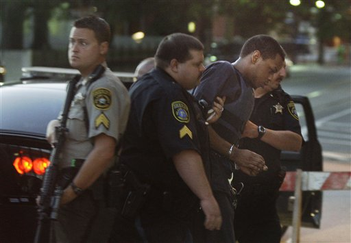 Abdulhakim Muhammad, right, is escorted from a police car to the Pulaski County Courthouse.