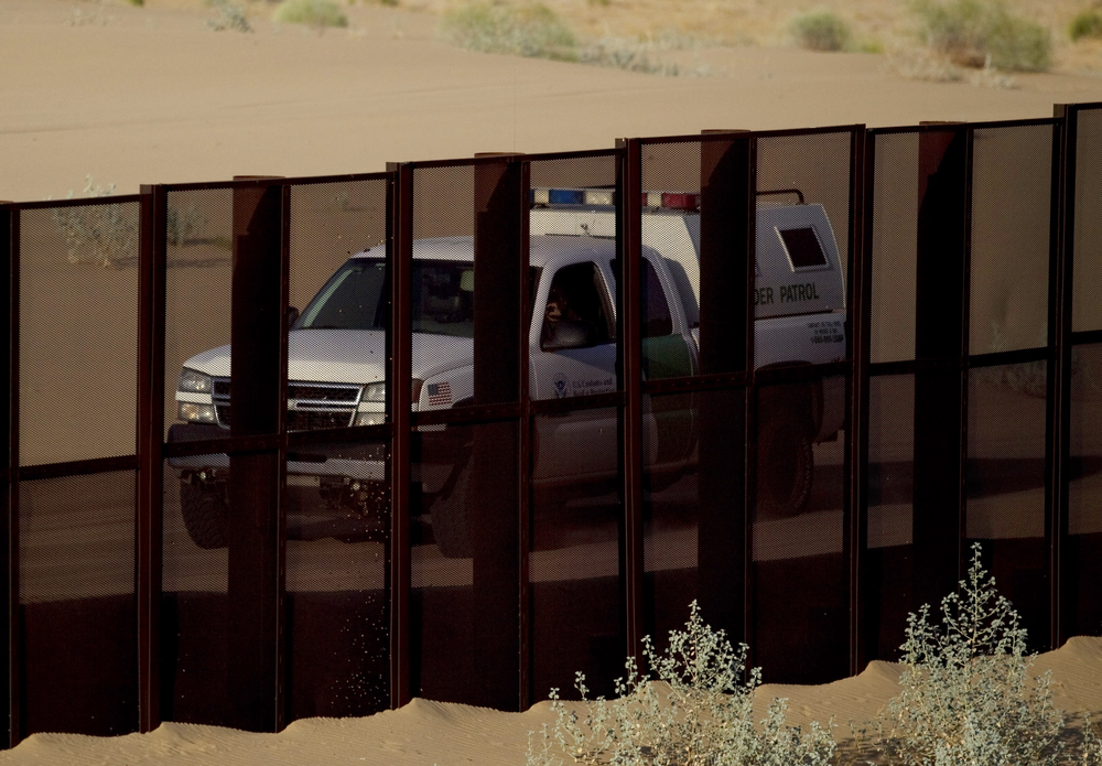 A border patrol vehicle drives along the U.S.-Mexico border fence near Yuma, Ariz.